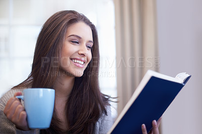 Buy stock photo Cropped view of a young woman enjoying a good book
