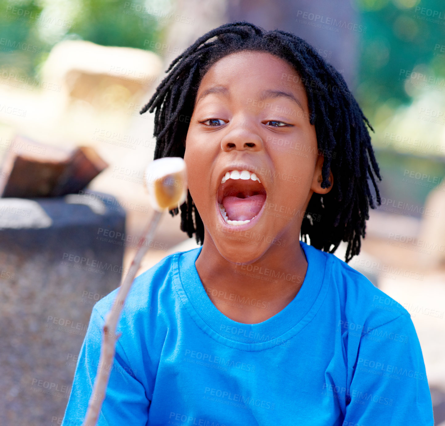 Buy stock photo Child, eating and barbecue marshmallow outdoor, camping and hungry bite of dessert or sweets. Excited, kid and roasting candy on stick in park, woods or forest on holiday or vacation with food