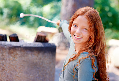 Buy stock photo Girl, smile and portrait by fire with marshmallow for camping adventure, summer and vacation for fun outdoors. Child, happy and face by barbecue with stick on holiday, outside and freedom to relax