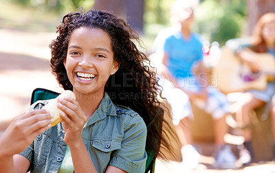 Buy stock photo Kid, eating and portrait with hotdog outdoor in camping chair and relax at barbecue with lunch. Happy, girl and hungry for food from bbq in park, woods or forest on holiday or vacation in summer