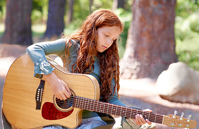 Buy stock photo Nature, camp and girl child with guitar for entertainment, talent or music in woods or forest. Playing, musician and kid with acoustic string instrument outdoor in park or field on weekend trip.