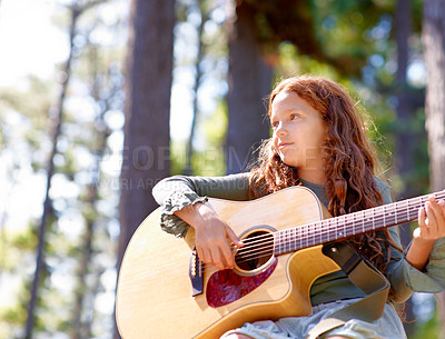 Buy stock photo Nature, camp and girl kid with guitar for entertainment, talent or music in woods or forest. Playing, musician and child with acoustic string instrument outdoor in park or field on weekend trip.