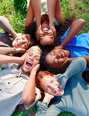 Buy stock photo Children, friends and cover ears in outdoors for silence, quiet and ignoring noise in nature. Diversity, kids and laughing for humor or funny joke on grass, top view and bonding in childhood for fun