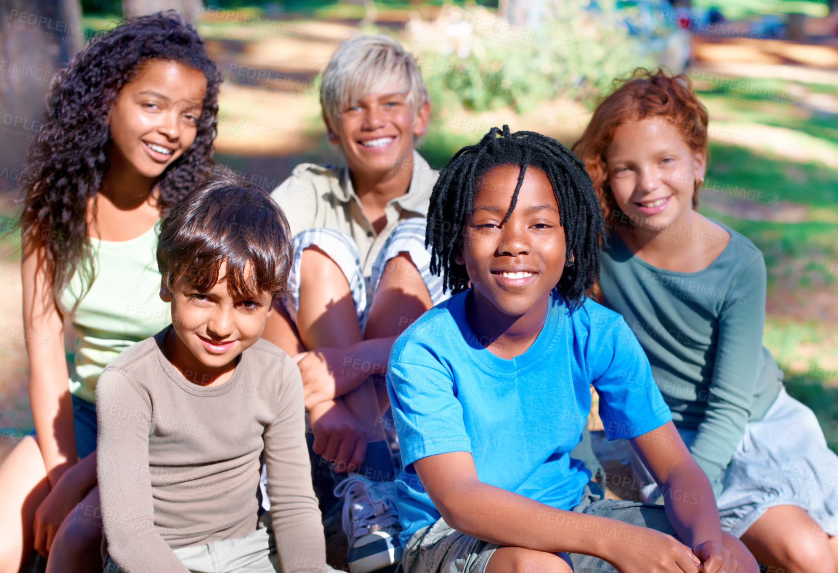 Buy stock photo A group of children smiling at the camera in the outdoors