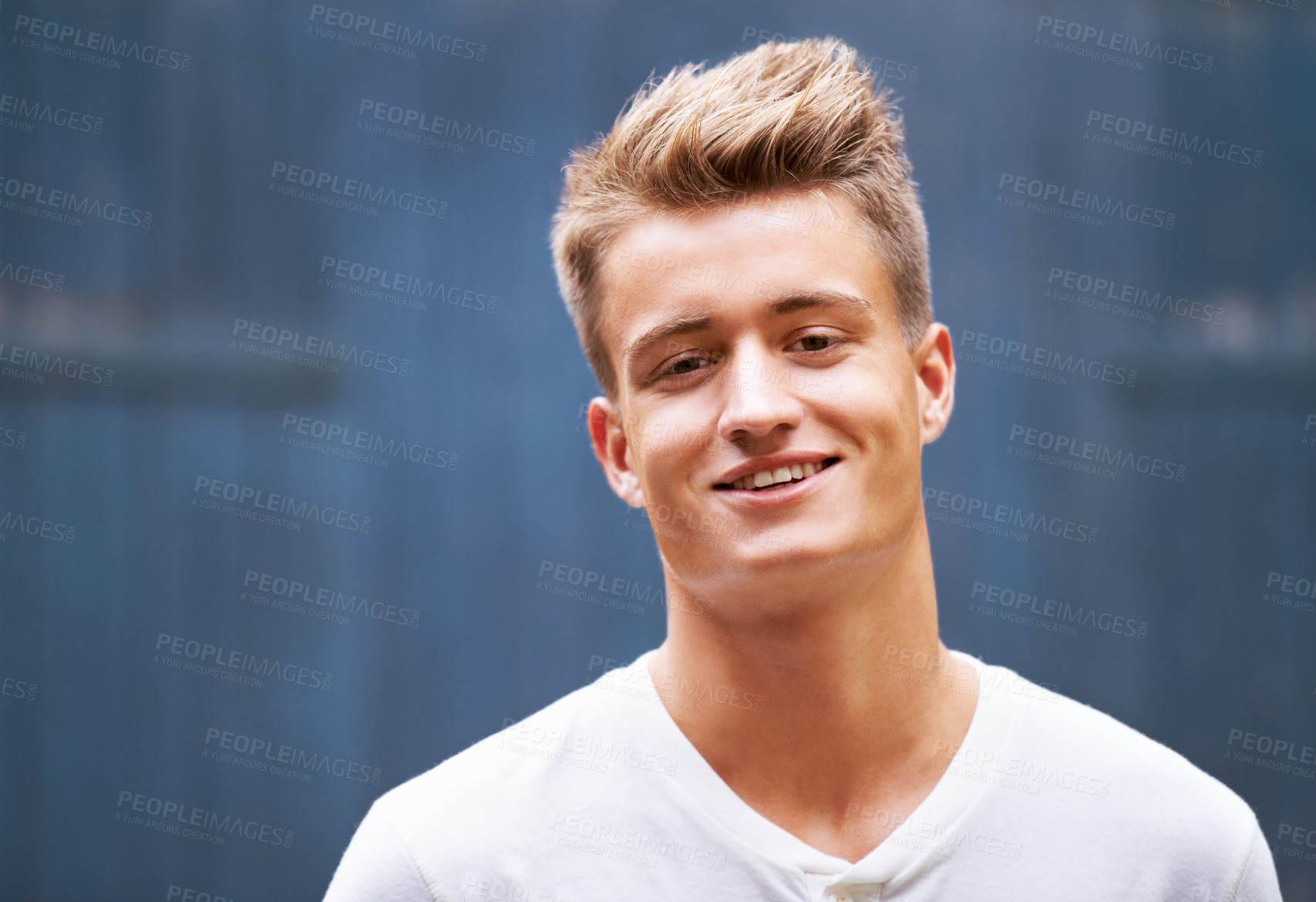 Buy stock photo Portrait, smile and young man with casual style on a wall background in the city. Relax, face and caucasian male person in a tshirt with trendy, cool fashion looking happy in New Zealand outdoors