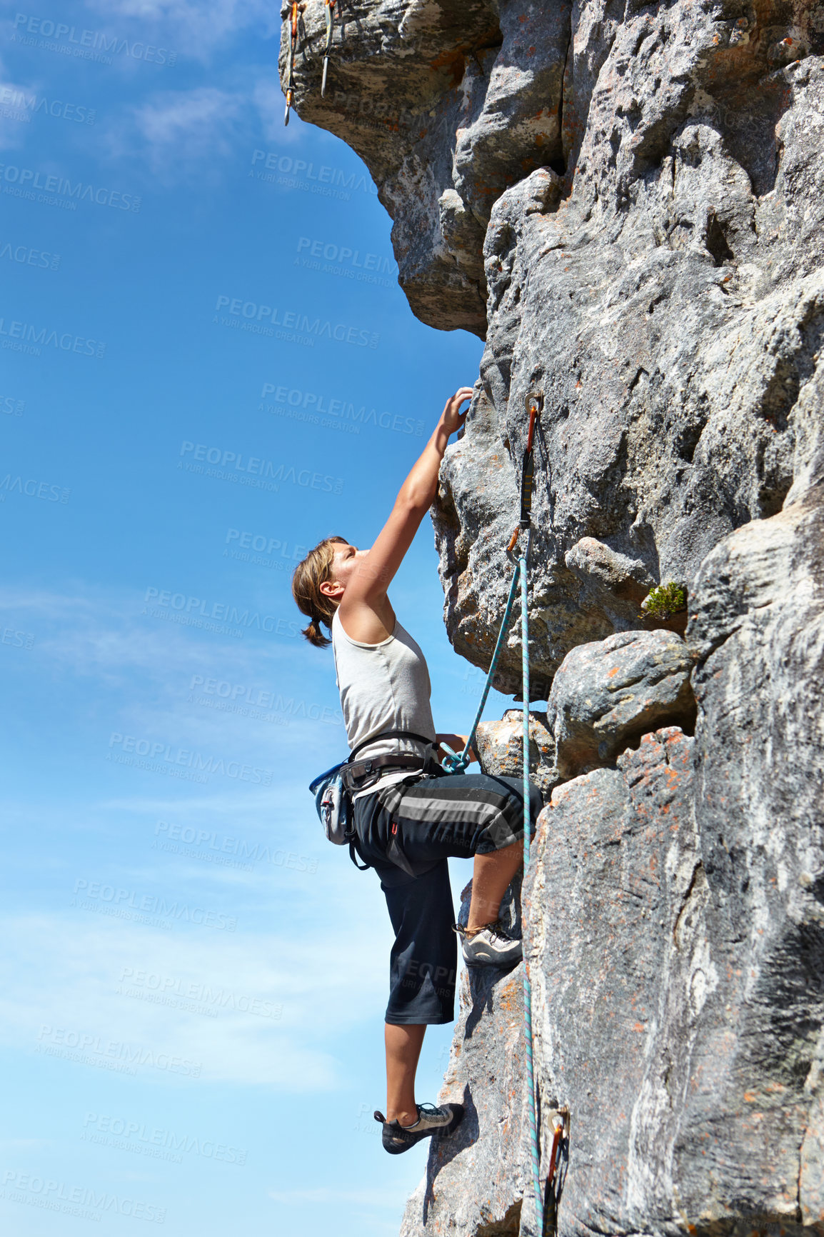 Buy stock photo Rock climbing, explore and challenge with woman on mountain for adventure, travel and fitness. Strong, freedom and blue sky with climber training in nature for courage, safety and workout mockup