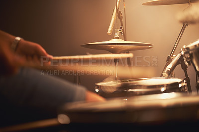 Buy stock photo Cropped image of a talented drummer hitting his drum skins hard at a gig