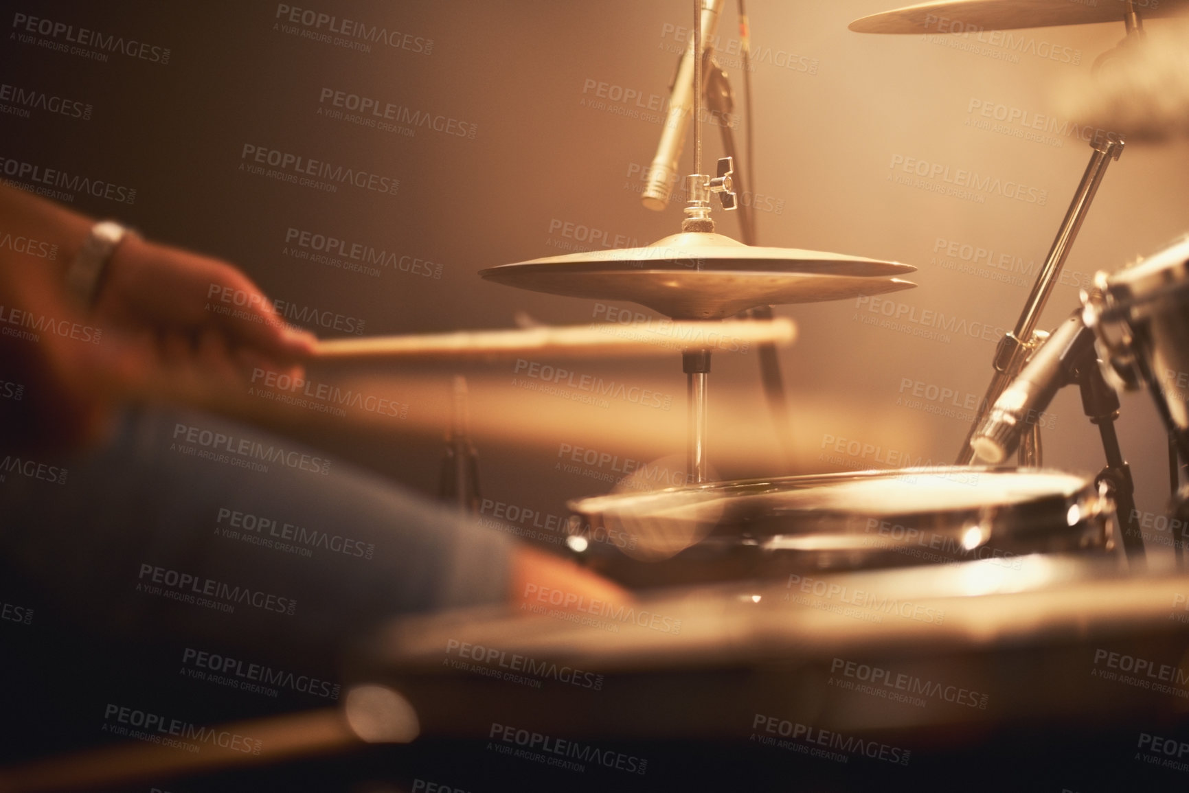 Buy stock photo Cropped image of a talented drummer hitting his drum skins hard at a gig