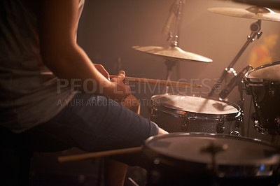 Buy stock photo Hands, drummer and musician in performance at rock concert, music festival on stage and band. Closeup, artist and playing on drumstick for entertainment, sound or rehearsal on percussion instrument