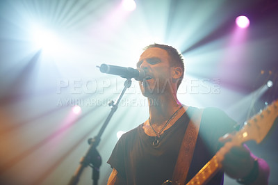 Buy stock photo Singing, concert and man with guitar and microphone for song and performance disco. Live show, male person and artistic musical club for new years eve party and event with energy for entertainment