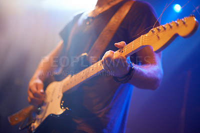Buy stock photo A guitarist playing his heart out beneath the strobe lights 
