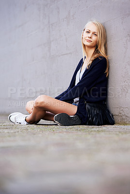 Buy stock photo Fashion, portrait and woman by wall in city, relax and outdoor alone. Beauty, style and young person in urban town, casual clothes and blonde girl sitting on the ground on mockup space in Switzerland