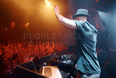Buy stock photo Concert, party or man in music festival to dj for performance or celebration with fans or audience. Stage, night or musician with hand up or crowd of people at a rave event with turntable technology