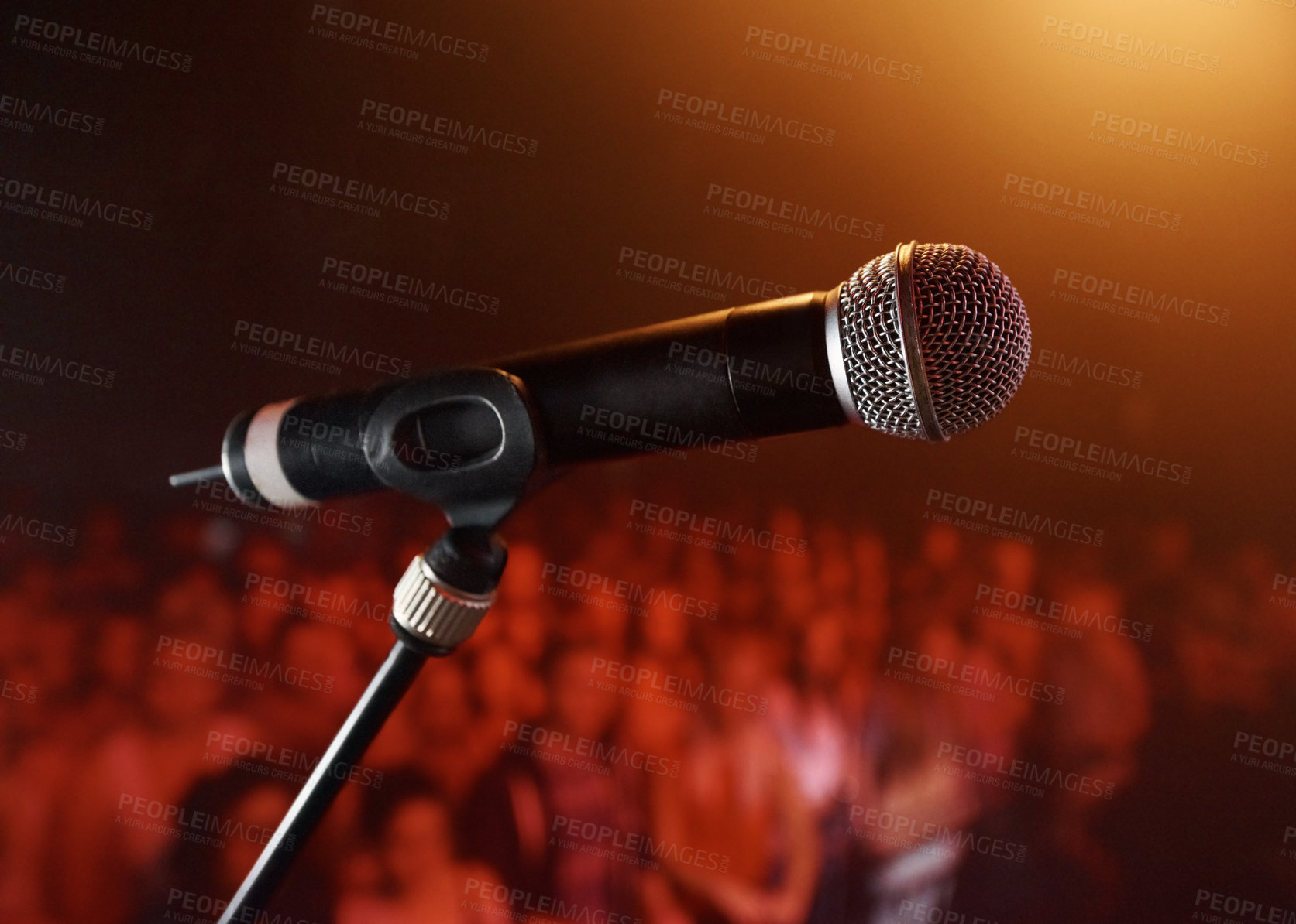 Buy stock photo A microphone standing on a stage with a crowd in the background