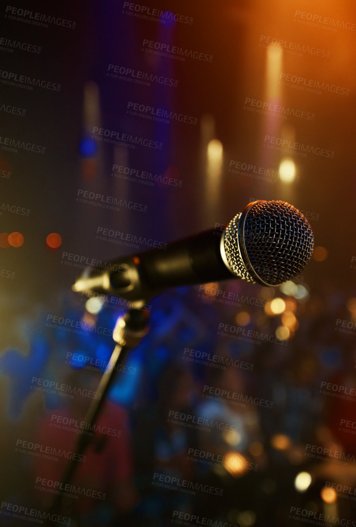Buy stock photo Microphone, closeup and stage performance in theater with sound equipment for concert or singing. Audio, technology and light in dark room with audience for karaoke, music or event for culture
