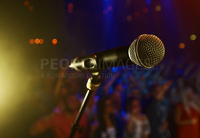Buy stock photo Closeup, microphone and stage performance in theater with audience and sound equipment for concert or singing. Audio, technology and light in dark room with crowd for open mic, karaoke or music event
