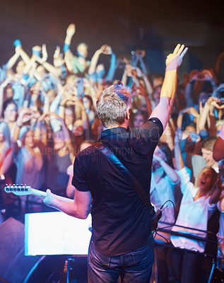 Buy stock photo Rear view of a band performing on stage to their fans