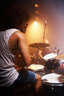 Buy stock photo Stage, performance and drummer at concert with man in band with energy and talent for music. Drums, musician and person playing in theater spotlight with rhythm for instrument and show at night