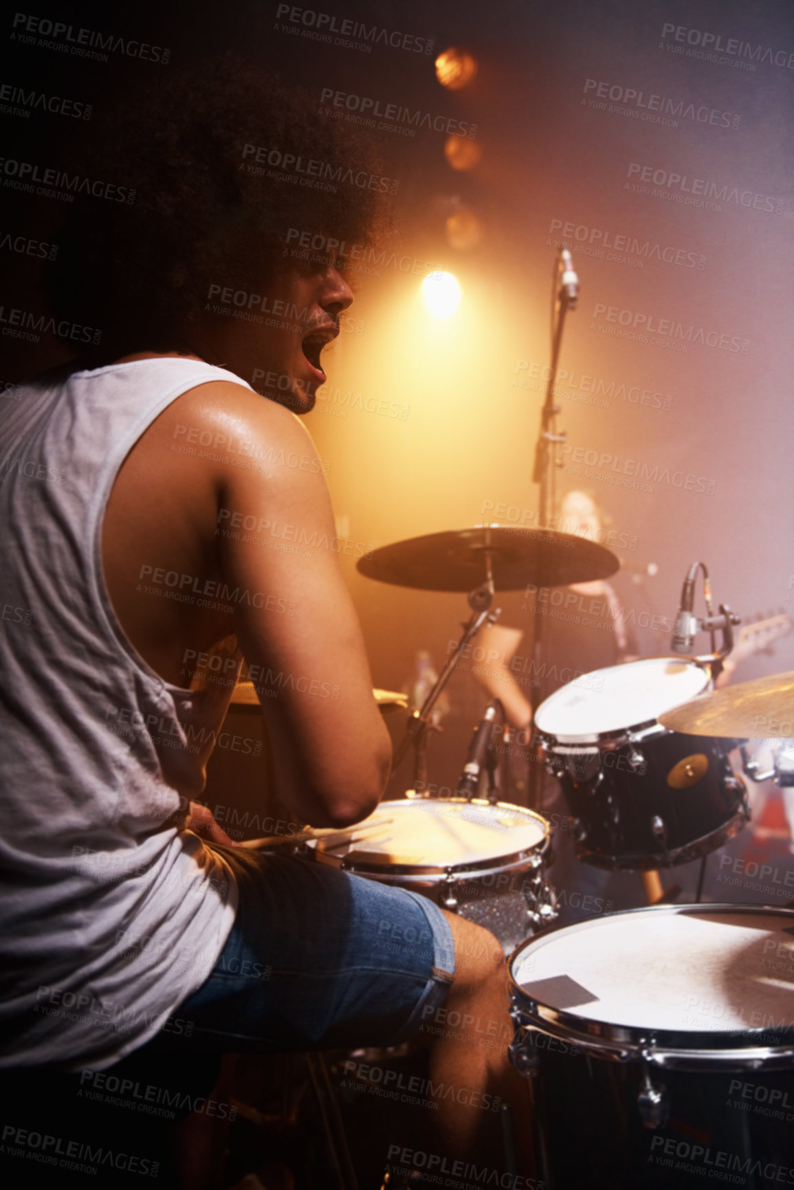 Buy stock photo Stage, performance and drummer at concert with man in band with energy and talent for music. Drums, musician and person playing in theater spotlight with rhythm for instrument and show at night