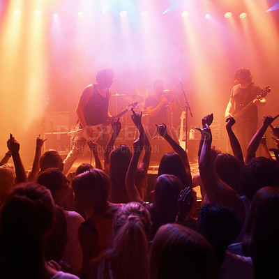 Buy stock photo Rearview of a crowd at a music gig with their hands raised in the air. This concert was created for the sole purpose of this photo shoot, featuring 300 models and 3 live bands. All people in this shoot are model released.