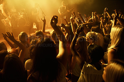 Buy stock photo Shot of a crowd dancing at a rock concert. This concert was created for the sole purpose of this photo shoot, featuring 300 models and 3 live bands. All people in this shoot are model released.