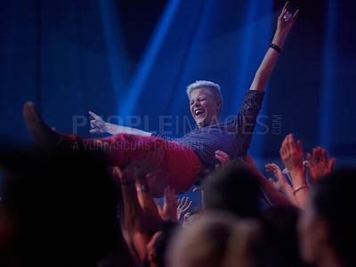 Buy stock photo A young person being carried across the crowd at a rock concert