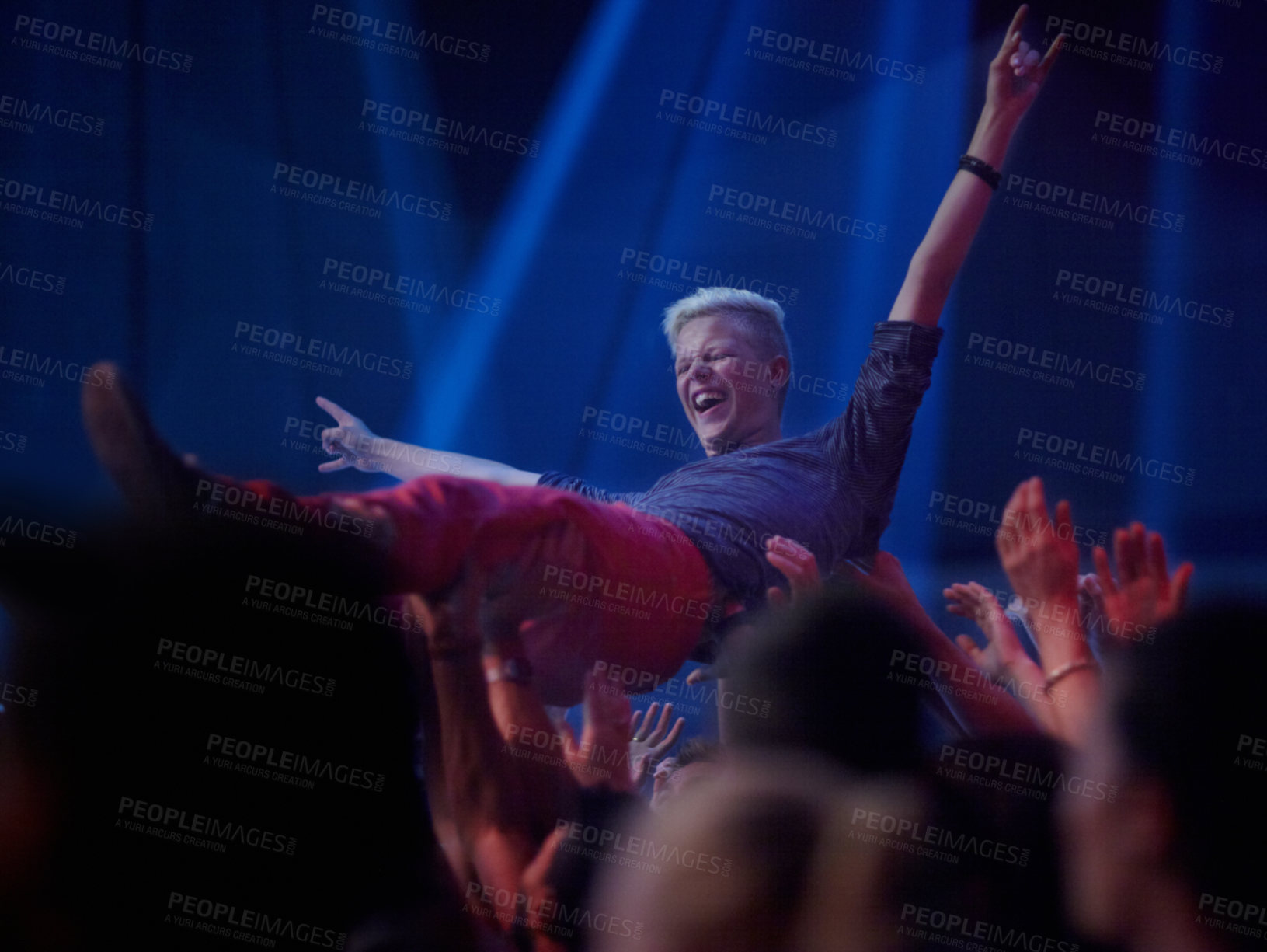 Buy stock photo A young person being carried across the crowd at a rock concert
