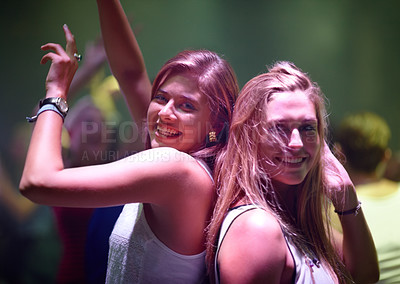 Buy stock photo A pretty young woman partying it up with friends in the club