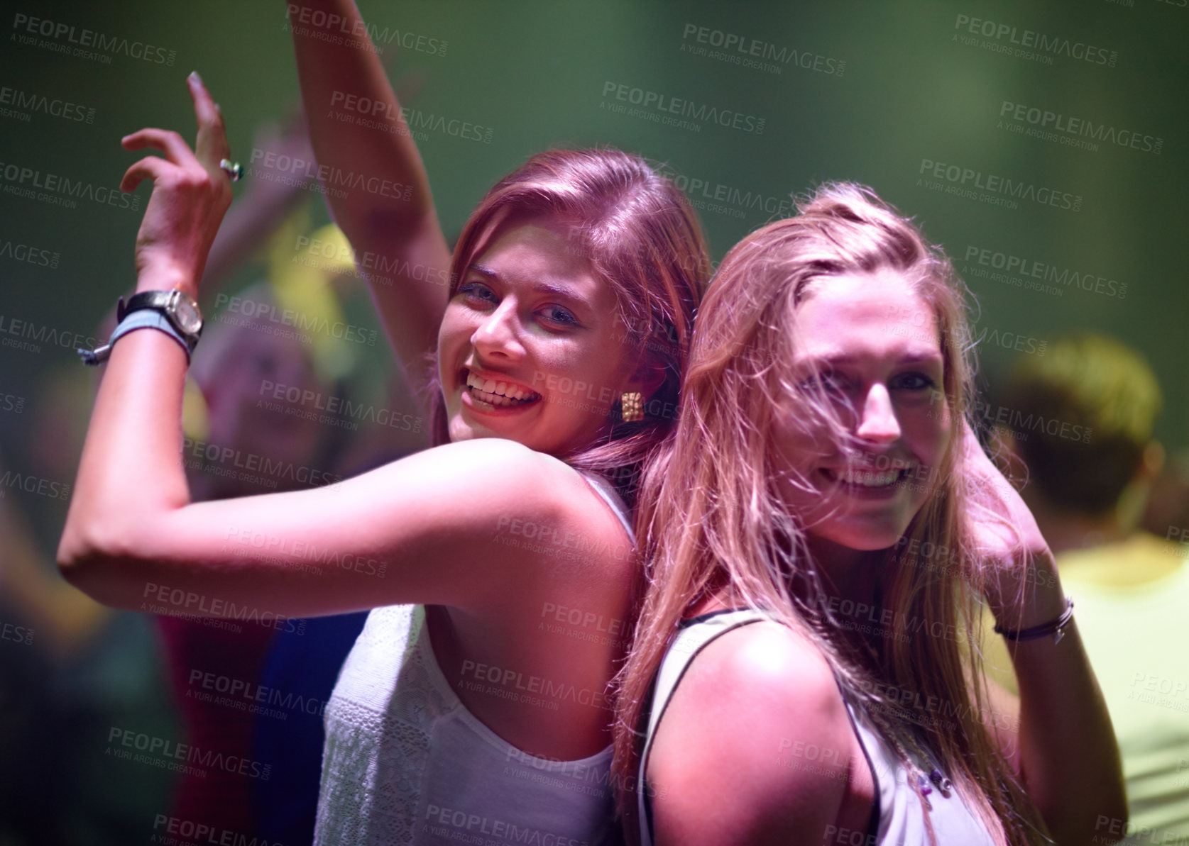 Buy stock photo A pretty young woman partying it up with friends in the club