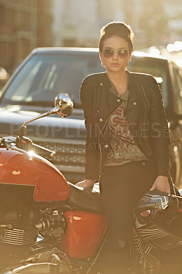 Buy stock photo Bike, leather and woman in city with sunglasses for travel, transport or road trip as rebel. Fashion, street and model with attitude on classic or vintage motorcycle for transportation or journey