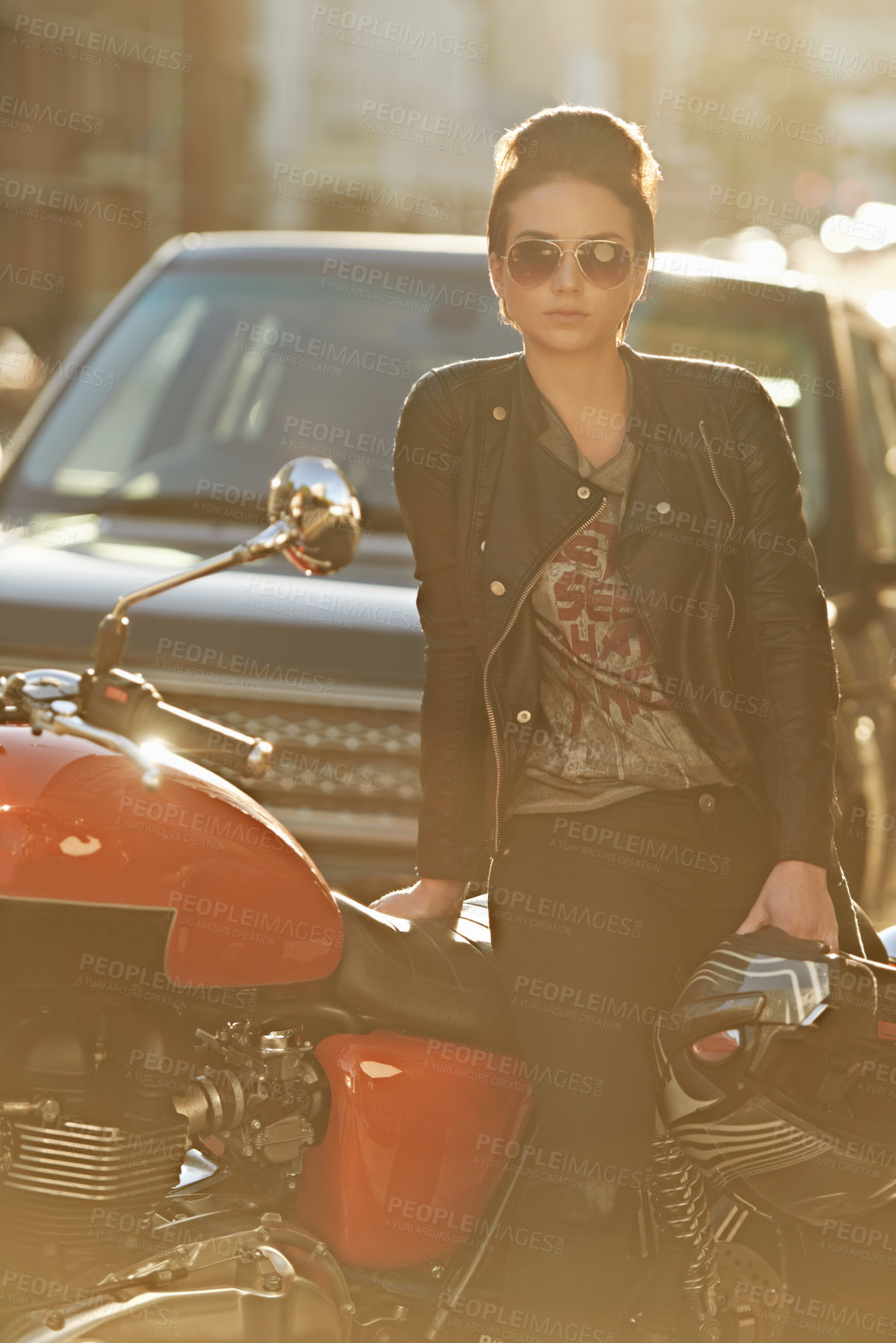 Buy stock photo Bike, leather and woman in city with sunglasses for travel, transport or road trip as rebel. Fashion, street and model with attitude on classic or vintage motorcycle for transportation or journey