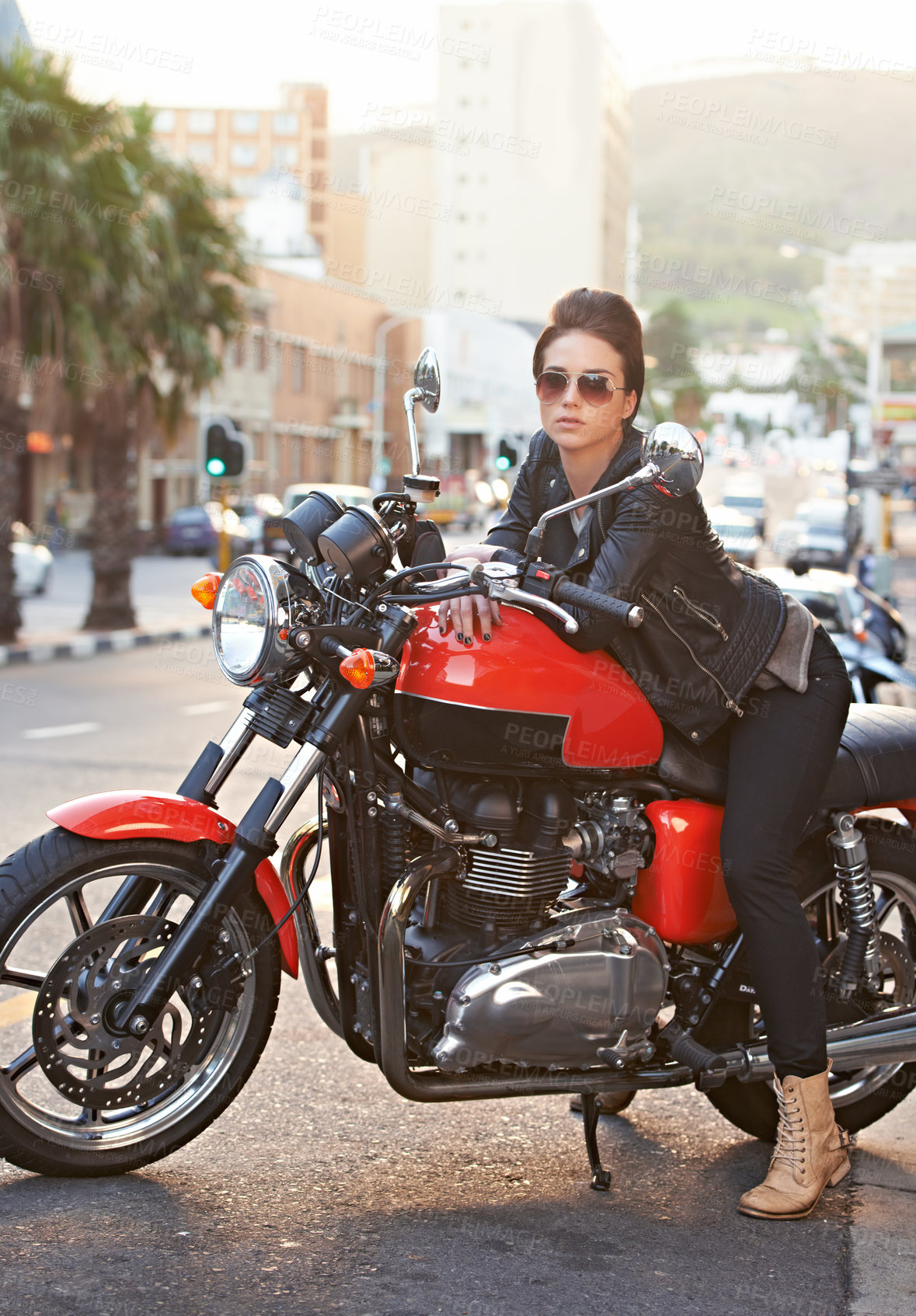 Buy stock photo Motorcycle, leather and woman in city with sunglasses for travel, transport or road trip as rebel. Fashion, street and model with attitude on classic or vintage bike for transportation or journey