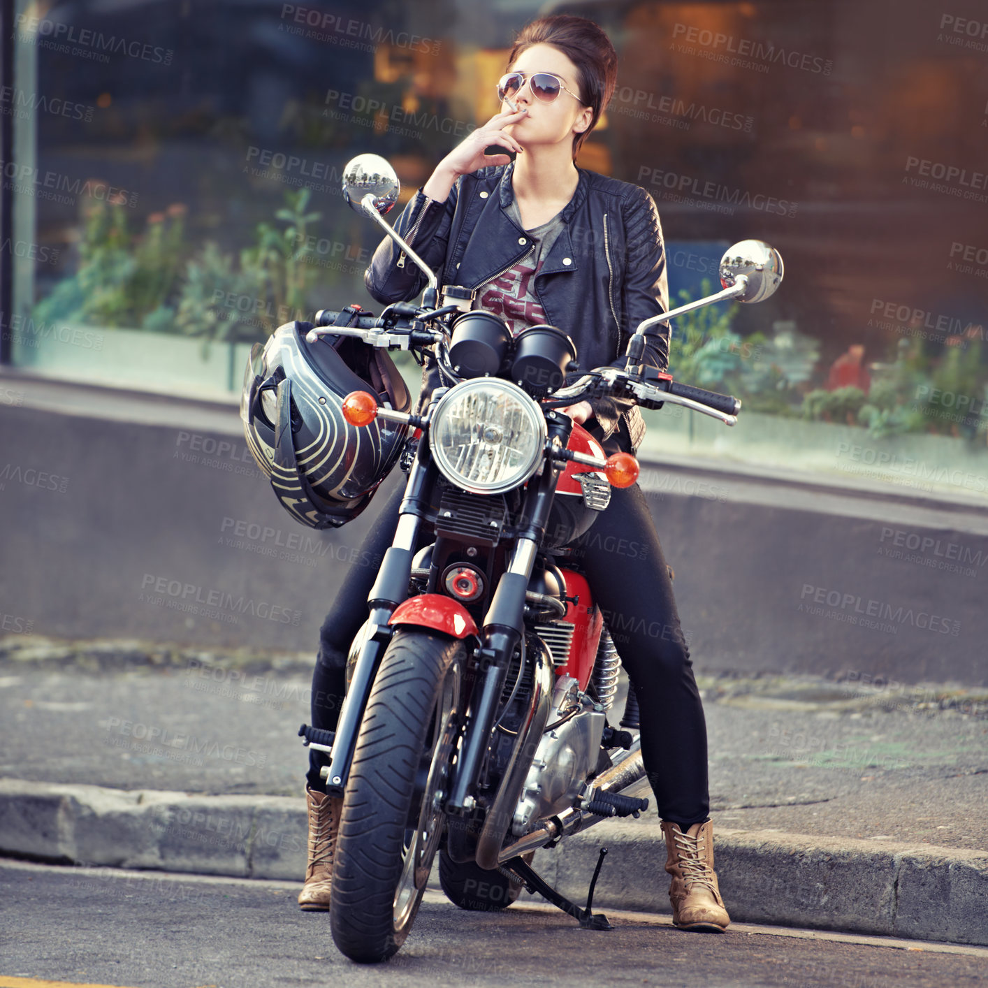 Buy stock photo Motorcycle, leather and smoke with woman in city for travel, transport or road trip as rebel. Fashion, cigarette and sunglasses with model on classic or vintage bike for transportation or journey