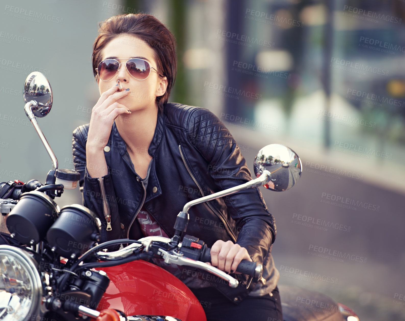 Buy stock photo Motorcycle, leather and biker in city with cigarette for travel, or road trip as rebel. Fashion, street and woman smoker with attitude on classic or vintage bike for transportation or journey