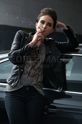 Buy stock photo Woman, waiting and smoking cigarette on car in parking lot for pick up or transportation. Female person, smoker or driver in fashion with leather jacket and inhaling tobacco by stationary vehicle