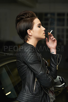 Buy stock photo Female driver, edgy and smoking for thinking, break and insight with car, garage and cigarette. Punk, fashion and model with grunge, vehicle and night for tobacco, choice and decision or mystery