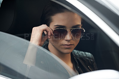 Buy stock photo Shot of an attractive young driver looking through the front windshield