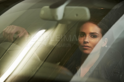 Buy stock photo Woman, driver and look through windshield, portrait and car for transportation and night commute. Female, travel and vehicle pose for business, action and actress shot for commercial or movie scene