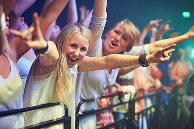 Buy stock photo Women, music and festival portrait in crowd at night with energy, happiness and excited smile. Gen z, cheerful and rocker fans enjoying live concert together with enthusiasm in Amsterdam.

