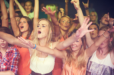Buy stock photo Concert, music festival and crowd of women or audience in night club, dance event and singing celebration with lights, disco and club lifestyle. Fans, group of people or youth at rave or techno party