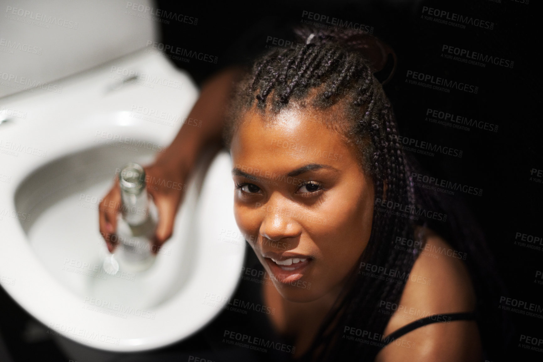 Buy stock photo Drunk, party and bathroom nausea of a black woman with a alcoholic problem and addiction. Toilet, drinking abuse and African female portrait with a beer bottle at night with alcohol drink feeling ill