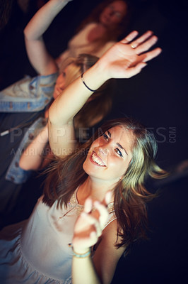 Buy stock photo Women, arms up or dancing in night party, music festival or social gathering event to live music, band performance or techno friends rave. Smile, happy or woman dancer on crowd dance floor and energy