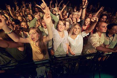 Buy stock photo Concert, music festival and crowd with rock hands sign for singing, dance and night event, performance and celebration in dark. Group of people, audience and gen z lifestyle techno, rave and party