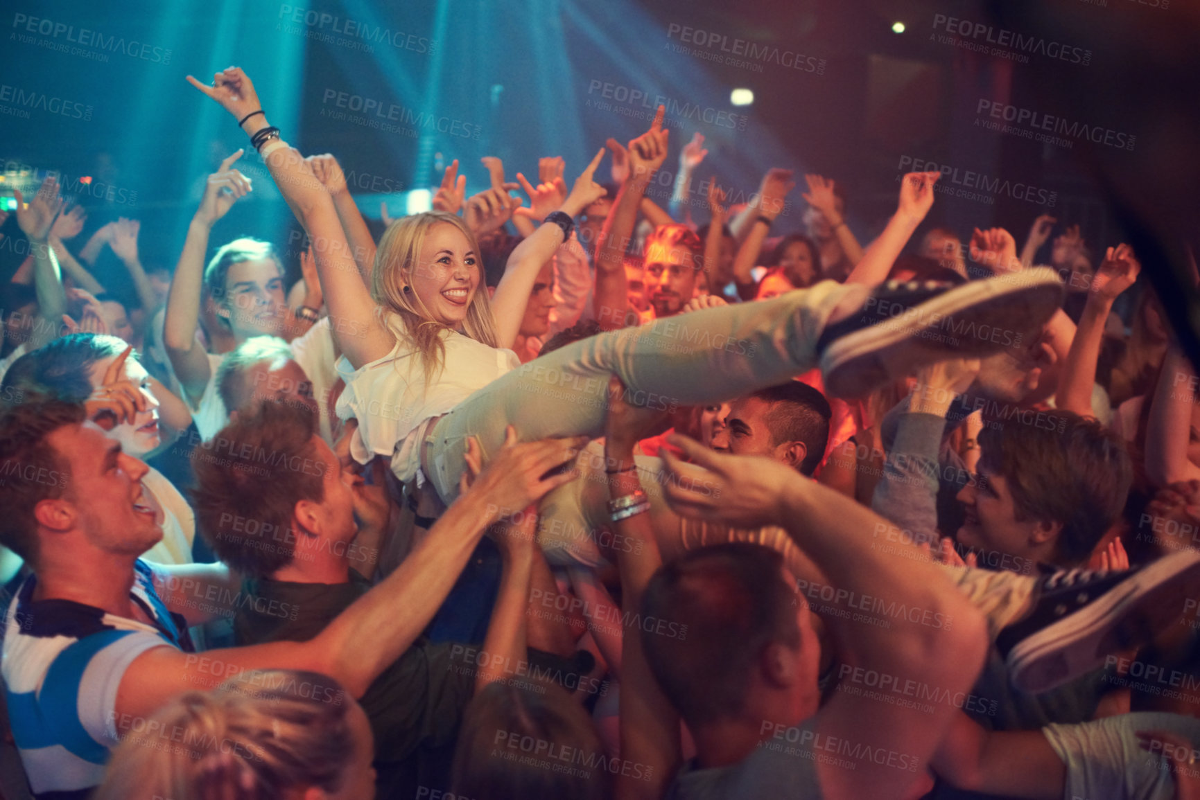 Buy stock photo Music, party and concert with a woman crowd surfing during a show or event in a stadium for performance. Festival, celebration and audience with a female enjoying live entertainment in an arena