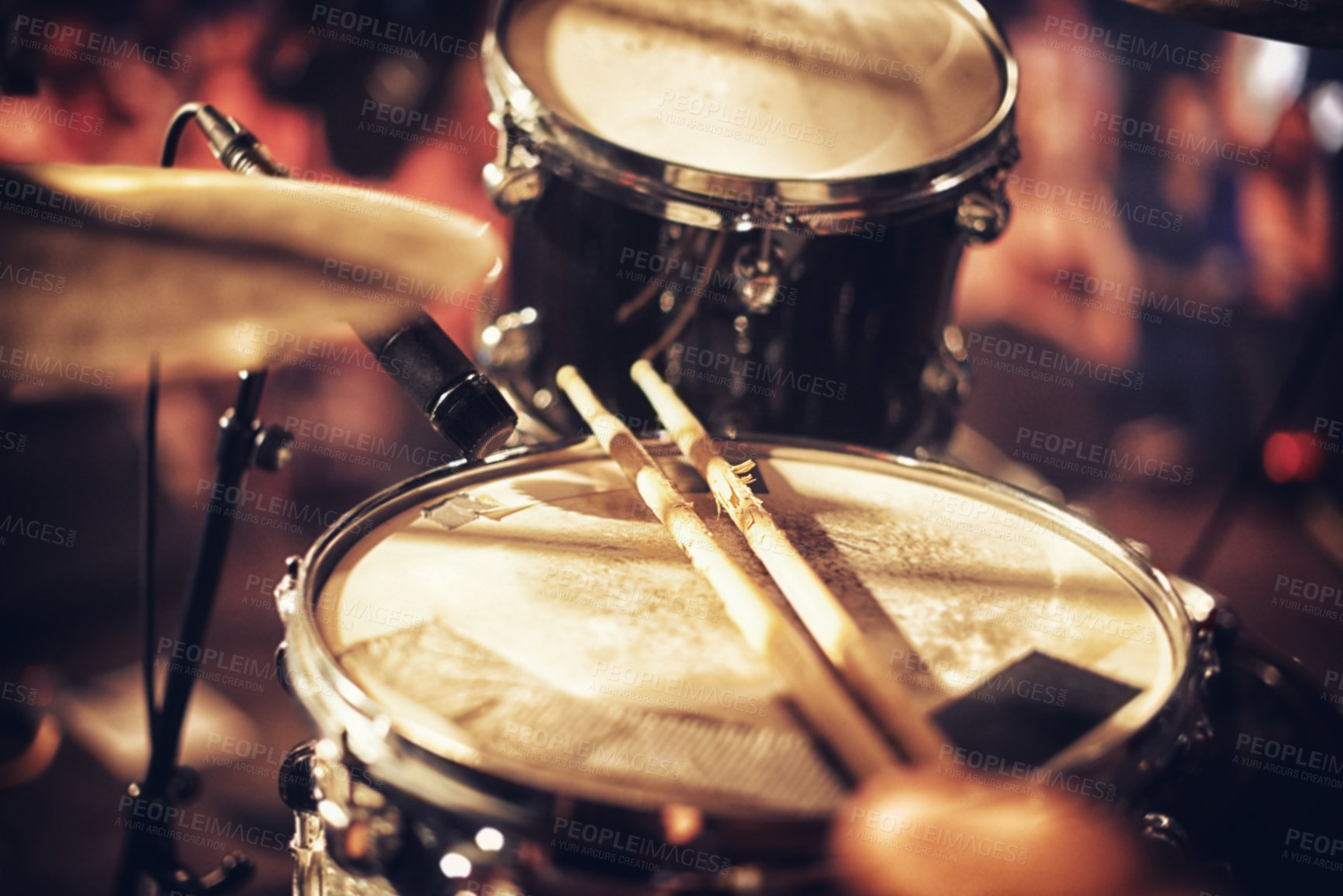 Buy stock photo Drum kit set up on a stage with a crowd in the background