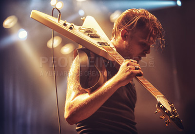 Buy stock photo Young musician carrying his guitar off-stage after a gig. This concert was created for the sole purpose of this photo shoot, featuring 300 models and 3 live bands. All people in this shoot are model released.