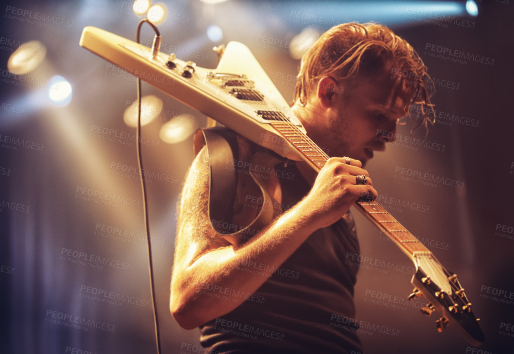 Buy stock photo Young musician carrying his guitar off-stage after a gig. This concert was created for the sole purpose of this photo shoot, featuring 300 models and 3 live bands. All people in this shoot are model released.