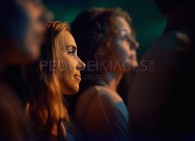 Buy stock photo Young woman looking at the stage at a concert. This concert was created for the sole purpose of this photo shoot, featuring 300 models and 3 live bands. All people in this shoot are model released.