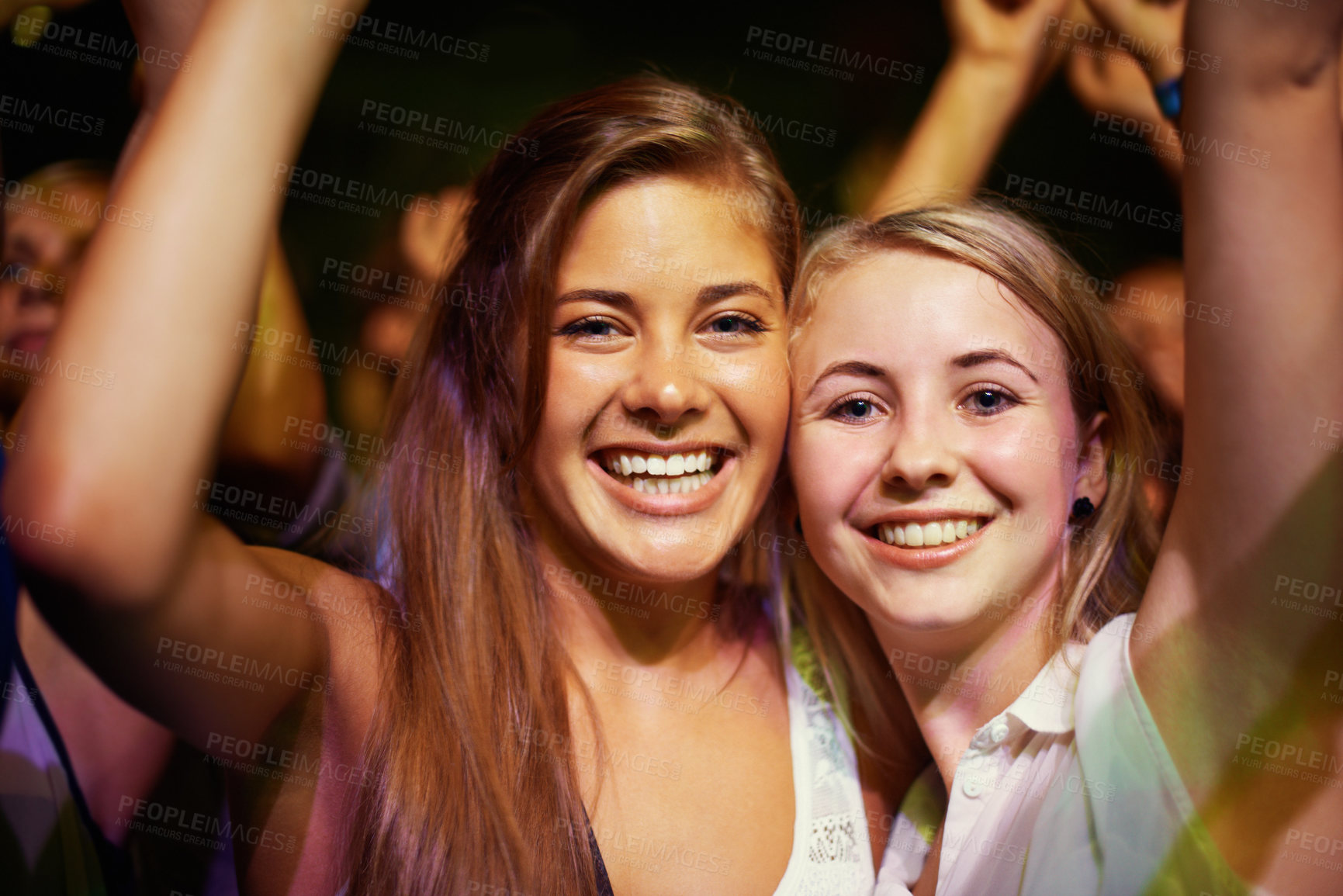 Buy stock photo Young girls in an audience enjoying their favourite band's performance