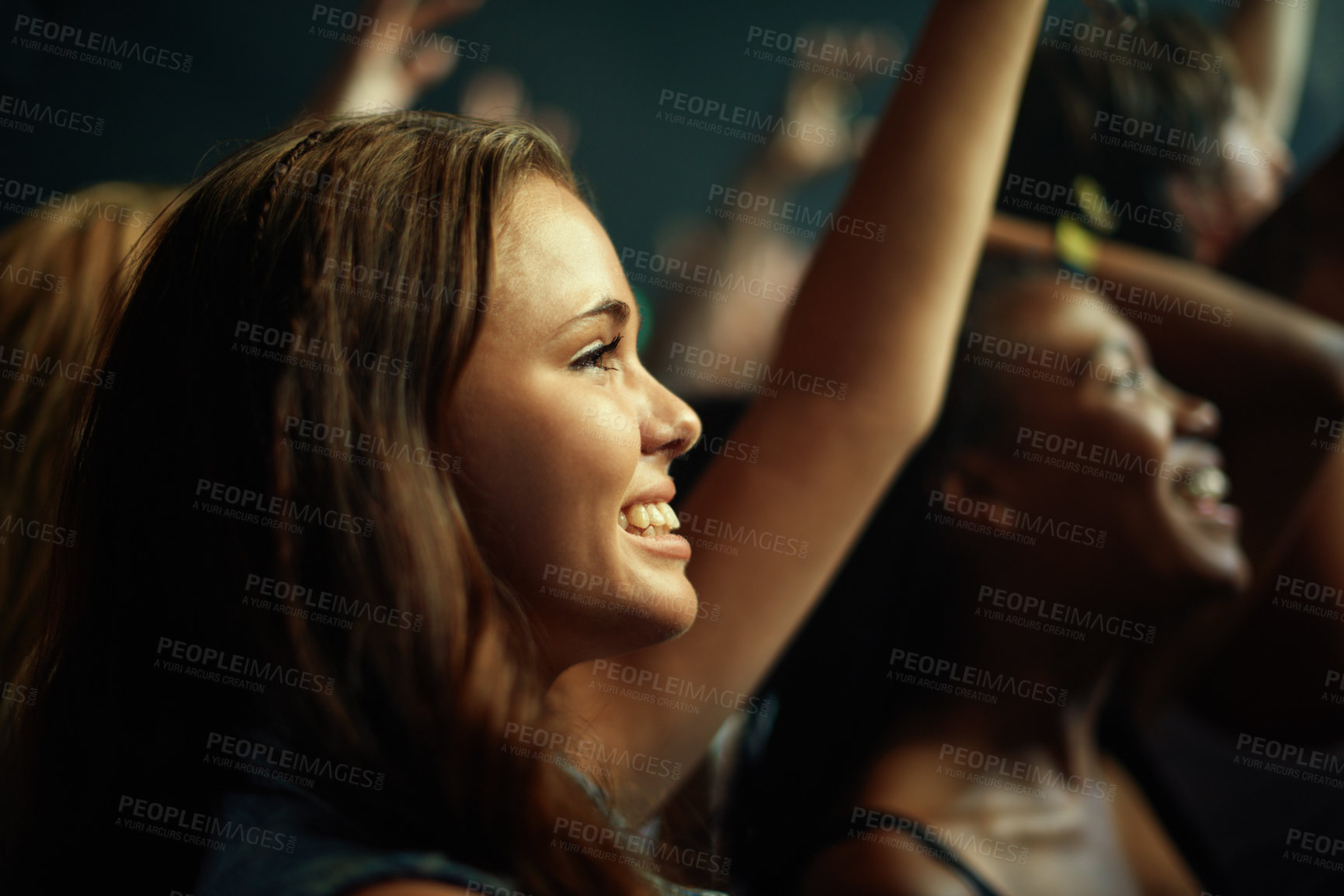 Buy stock photo Young girls in an audience enjoying their favorite band's performance. This concert was created for the sole purpose of this photo shoot, featuring 300 models and 3 live bands. All people in this shoot are model released.